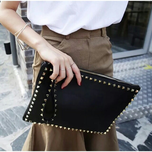 gold studded clutch bag