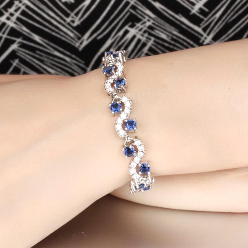 YOUNIQ Crescent CZ Platinum Plated Silver Bracelet (Blue)